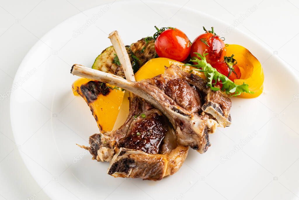 Modern French cuisine: Roasted Lamb neck & rack served with carrot, yellow curry and lamb sauce. 