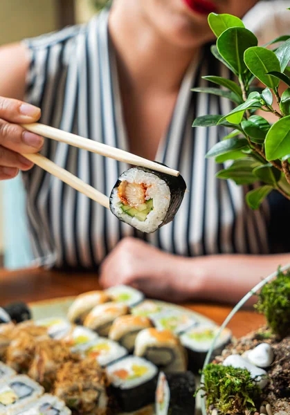 woman eating sushi in the restaurant