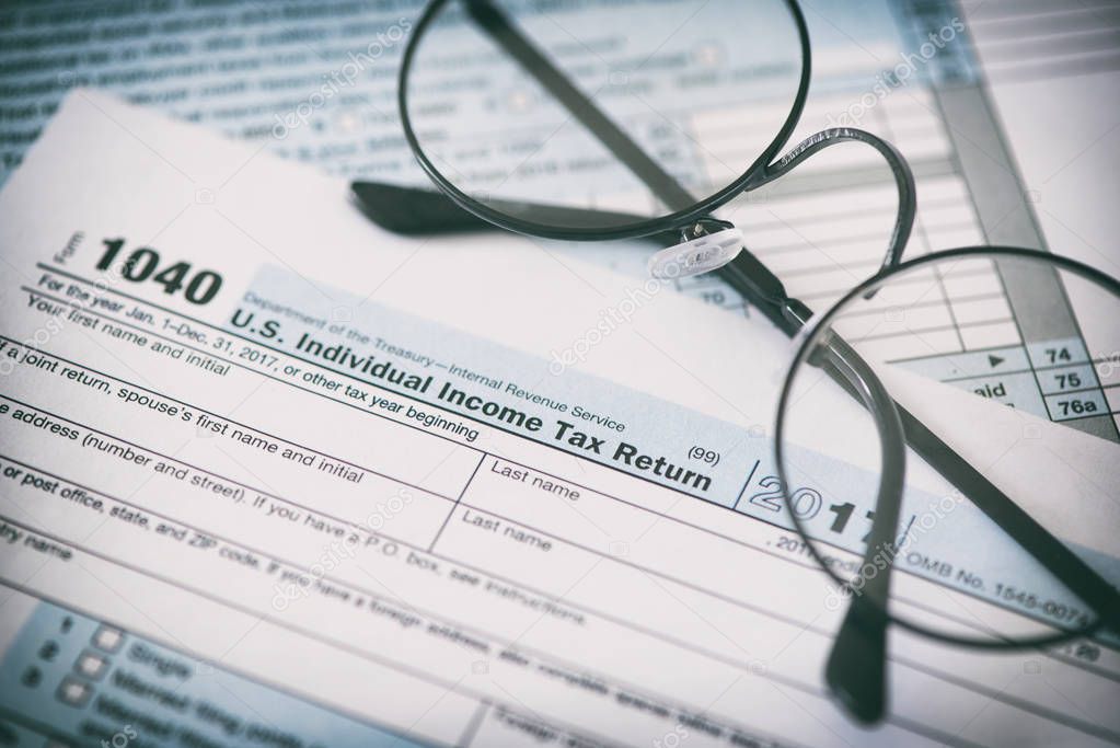 US tax form and glasses. Finance concept background