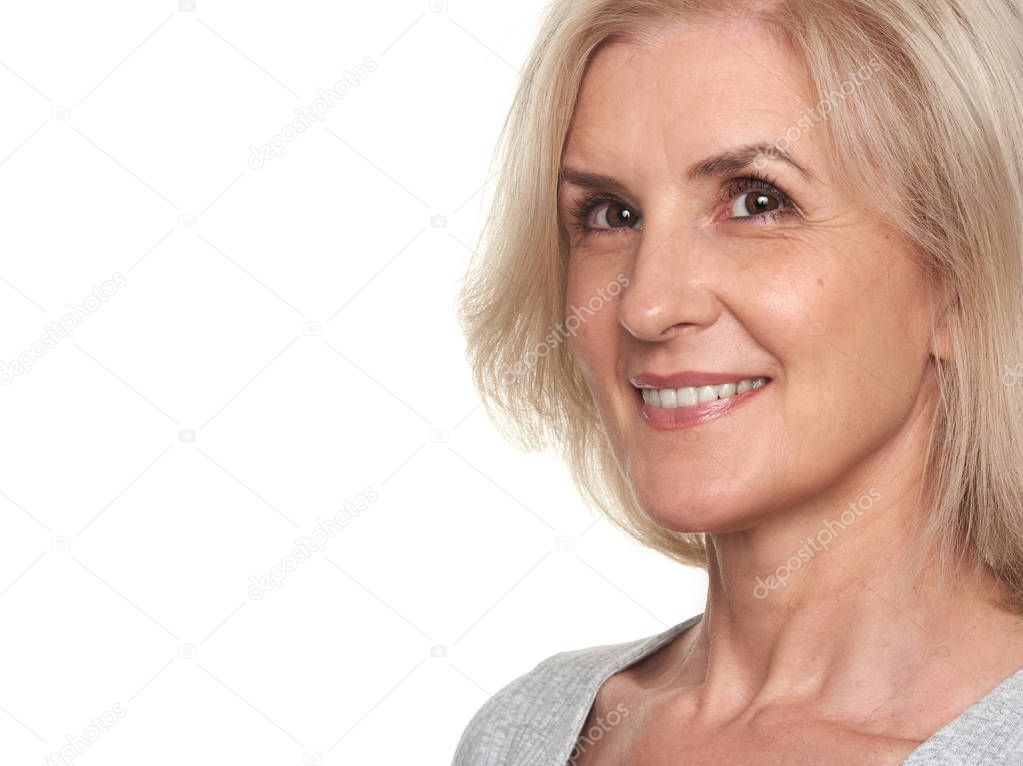 close up portrait of senior woman. Beautiful middle aged lady toothy smiling