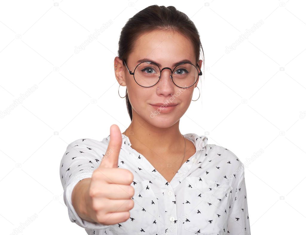 Happy young woman giving thumbs up. pretty girl wearing eyeglasses and smiling. Isolated on white