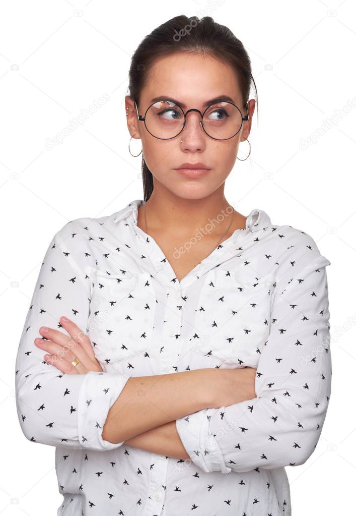 Young pretty woman wearing glasses and looking aside. Confident beautiful girl with arms crossed. Isolated on white