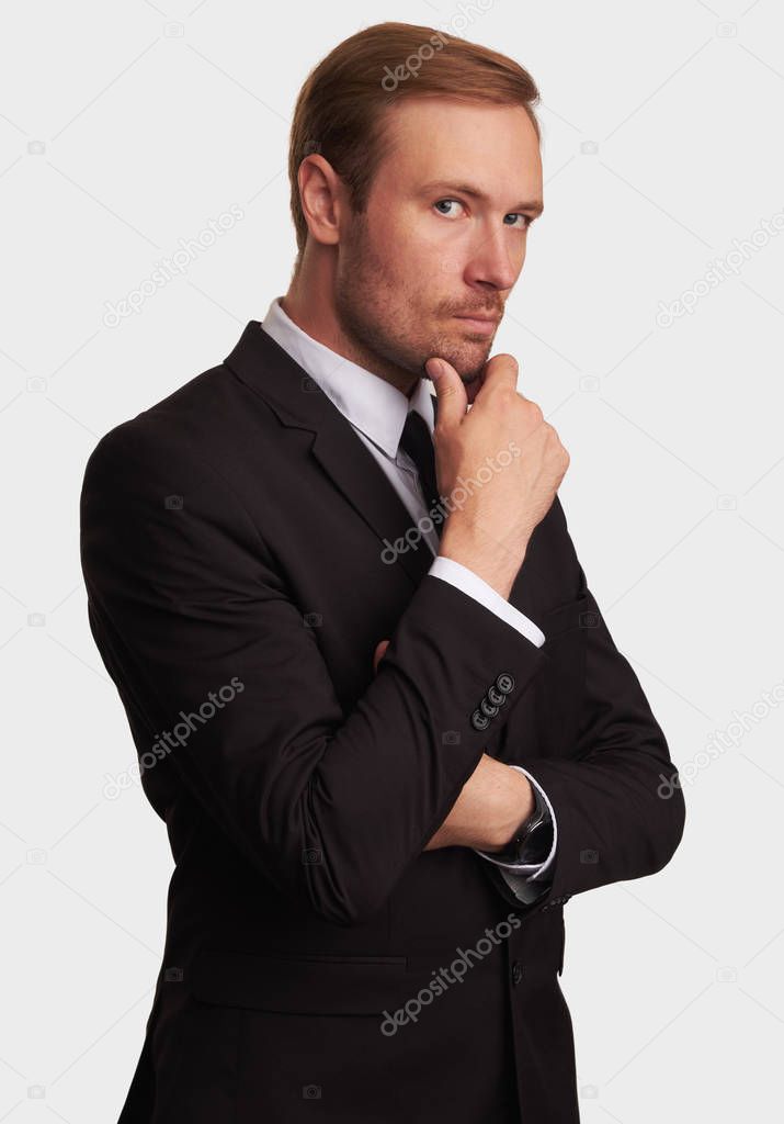 Serious businessman thinking. thoughtful handsome man in suit. Isolated on gray