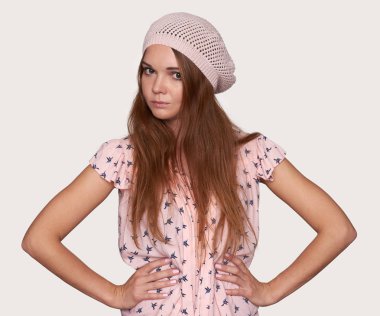 güzel hipster kadın giyiyor şapka. Kalça ellerinde olan kız. Gri studio arka plan üzerinde izole