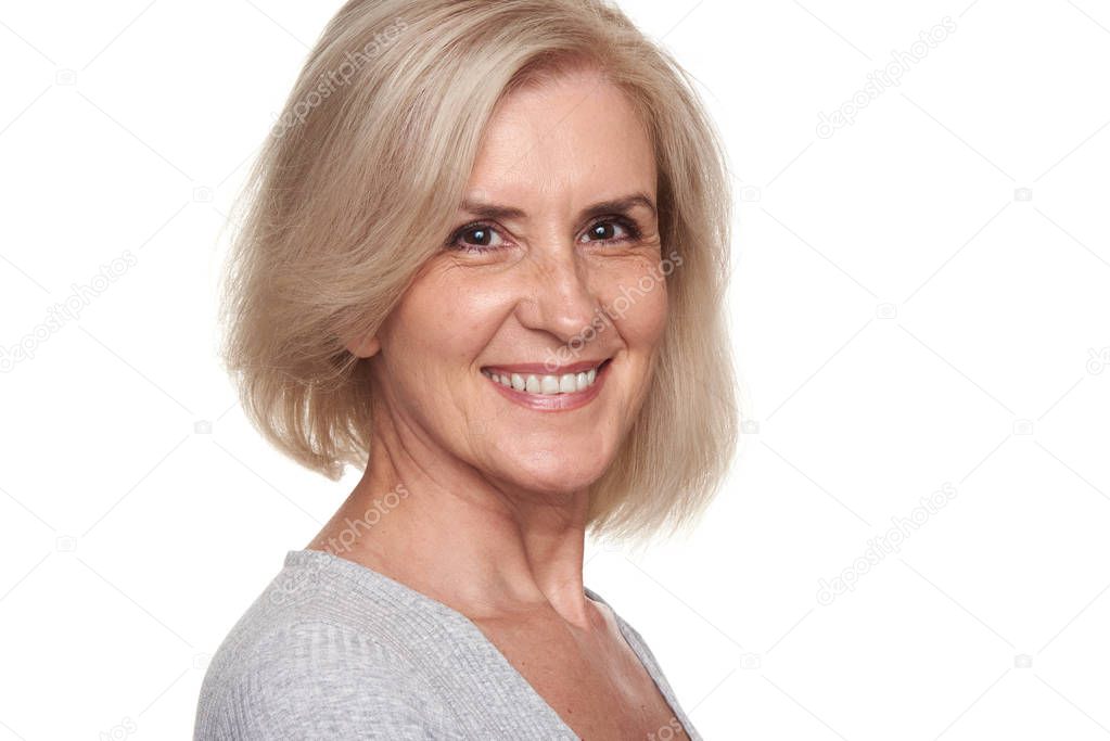 Cheerful pretty old lady is smiling. Skin and tooth care. Senior woman isolated on white background