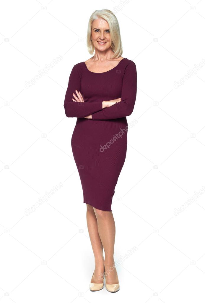 full length portrait of a beautiful blonde old woman is smiling and standing on white studio background