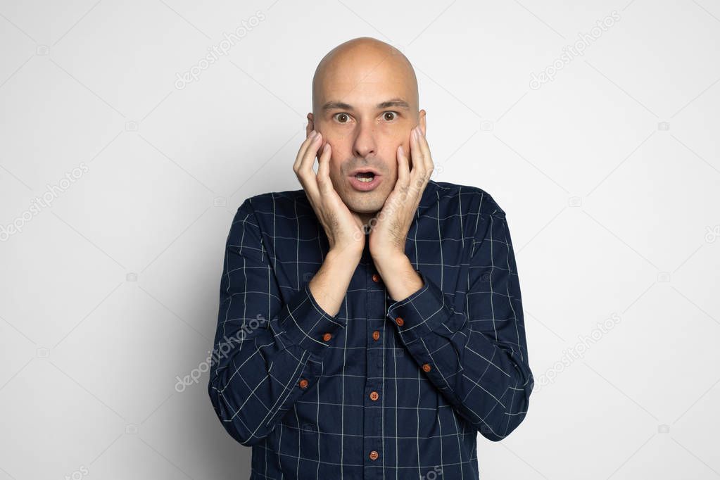 shocked man covering mouth with hands