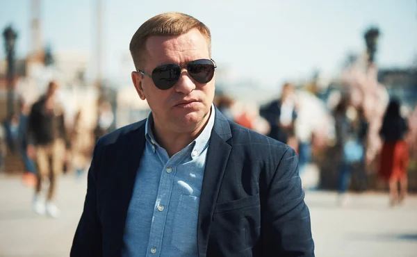 Серйозна людина носить сонцезахисні окуляри на вулиці. Портрет на відкритому повітрі — стокове фото