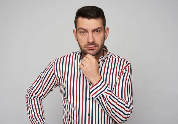 Earded handsome man wearing striped shirt thinking — Stock Photo, Image