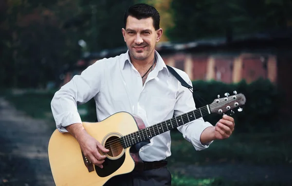 Man spelar gitarr på en gata — Stockfoto