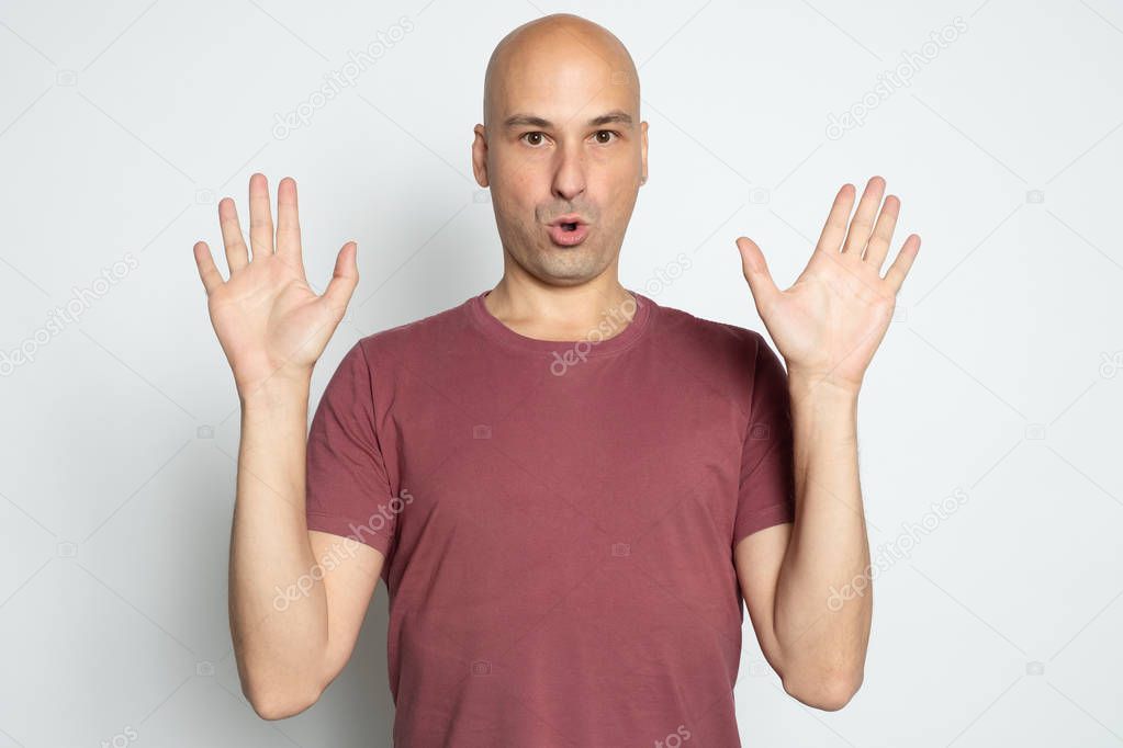 Bald man raised his arms up