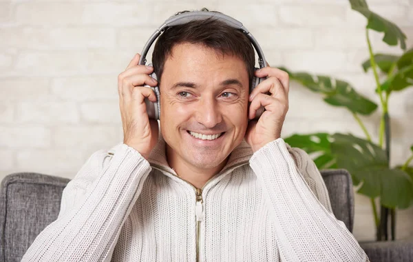 El hombre feliz está escuchando música en casa — Foto de Stock
