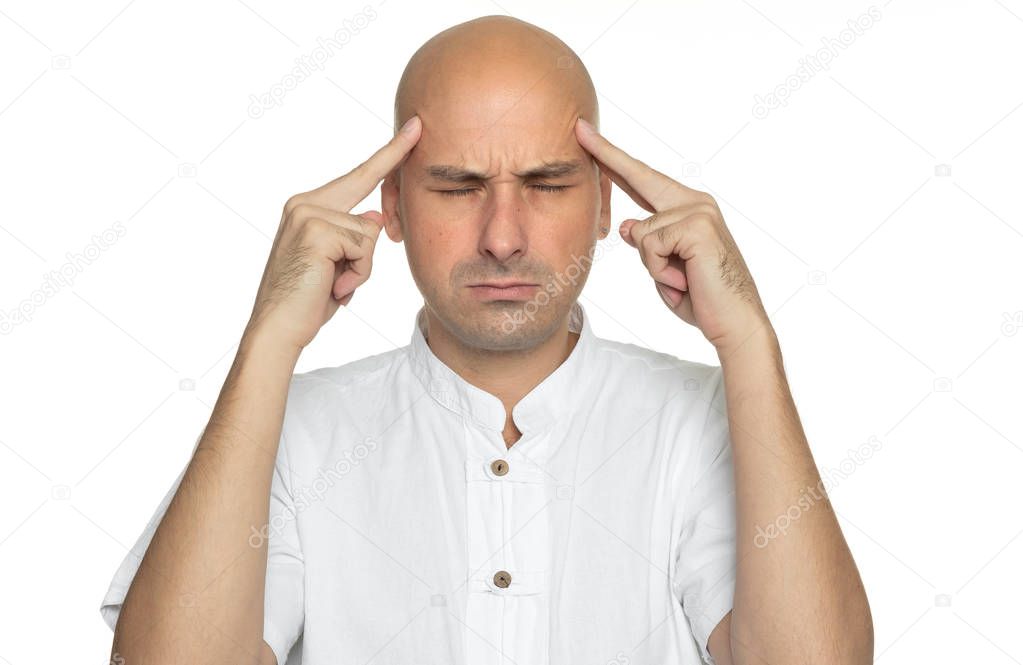 40 years old bald man with headache. Isolated