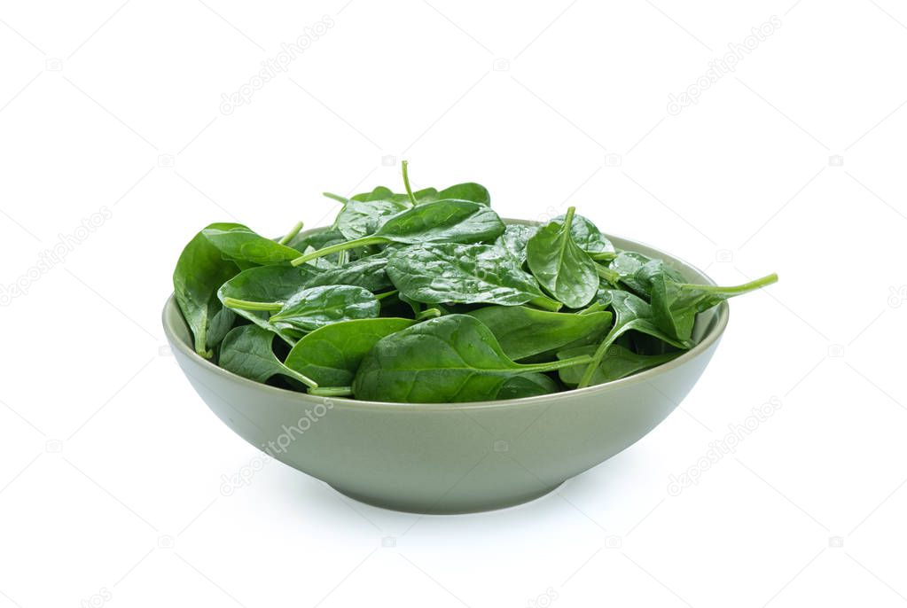 baby spinach leaves in a bowl isolated on white
