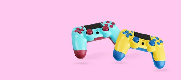 两个电子游戏控制器 粉色背景的Gamepads — 图库照片