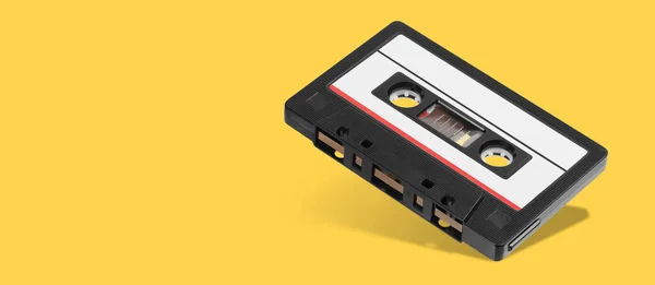 Old Black Audio Tape Compact Cassette Record Isolated Orange Background — Stock Photo, Image