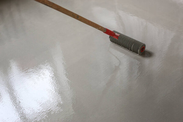 Contract painter painting garage floor to speed up selling of home