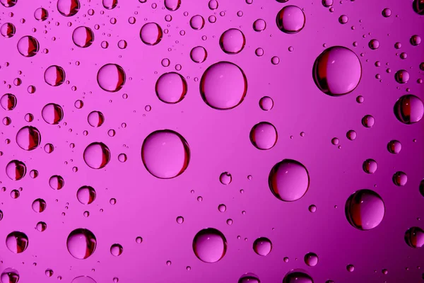 Dripped water on glass.Pink  abstract background