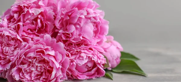 Flowers composition.  Pink peony flowers on wooden background.  Mothers day. Flat lay, top view.
