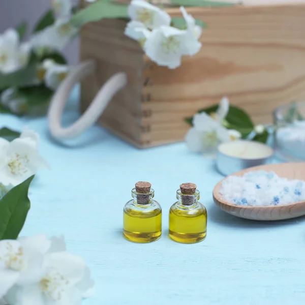 Aromatic oils, sea salt, candles and jasmine flowers.  Spa ingredients for massage and relaxation. — Stock Photo, Image