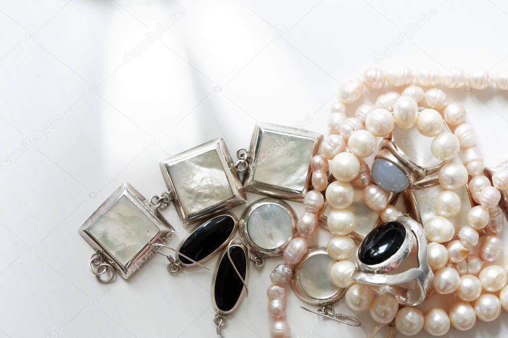 Set of various jewelry adornments on white background with free space