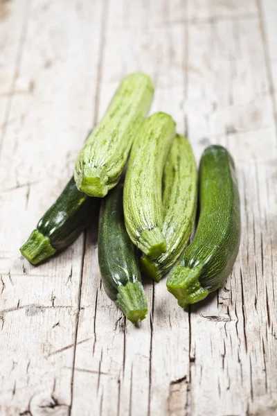 Fresh green zucchini on wooden rustic table. — Stock Photo, Image