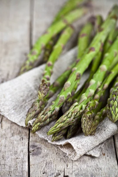 Un mazzo di asparagi da giardino freschi crudi e tovagliolo di lino — Foto Stock