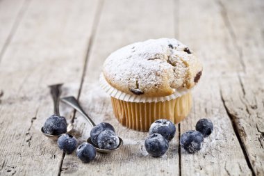 Toz şeker, vintage kaşık ve mavi ile ev yapımı taze muffin