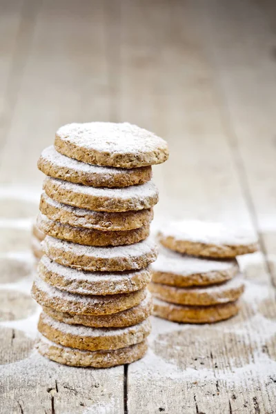 Fresh oat cookies with sugar powder closeup on rustic wooden tab — Stock Photo, Image