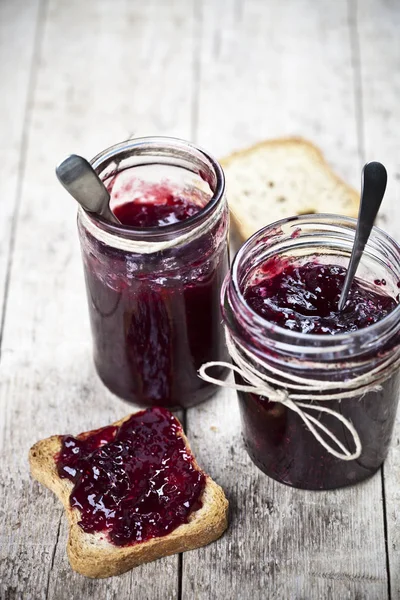 Cereal bread toasts slices and jars with homemade wild berries a — Stock Photo, Image