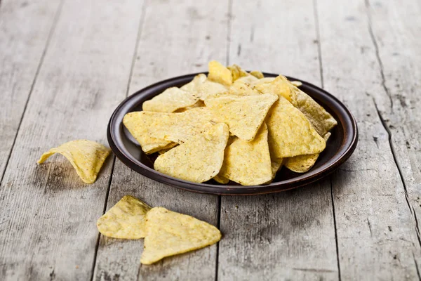 Nachos chips on brown ceramic plate. — Stock Photo, Image