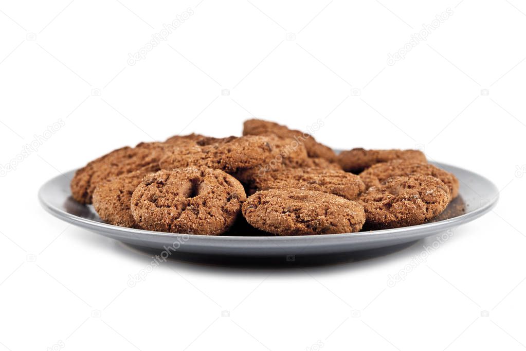 Fresh baked chocolate chip cookies heap on grey plate isolated o