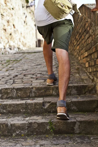 Walking upstairs: closeup view of man's legs brown leather shoes — Stock Photo, Image