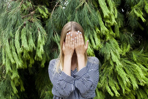 Bella giovane donna che nasconde il suo volto in piedi nella foresta aga — Foto Stock