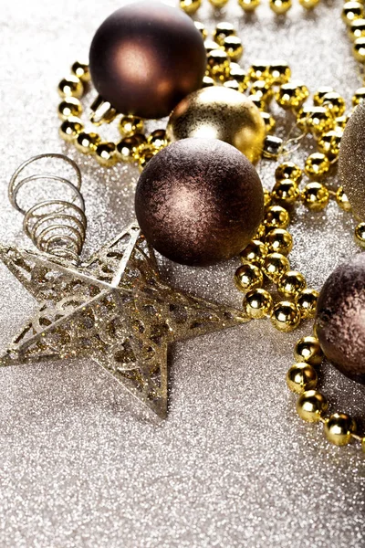 Christmas golden and brown decorations closeup on glitter backgr — Stock Photo, Image