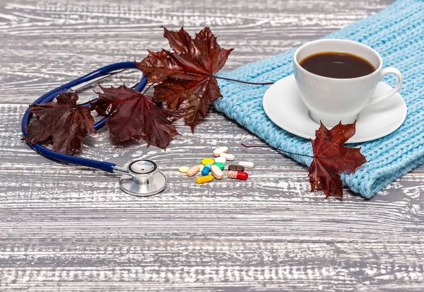 Cup Coffee Turquoise Scarf Stethoscope Pills Fallen Leaves Wooden Grey — Stock Photo, Image
