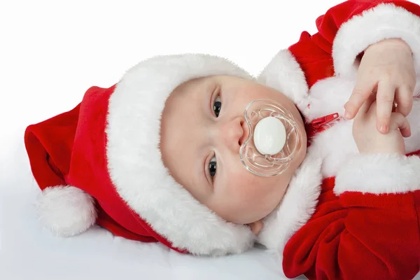 Six month old Santa with a pacifier, baby\'s dumm