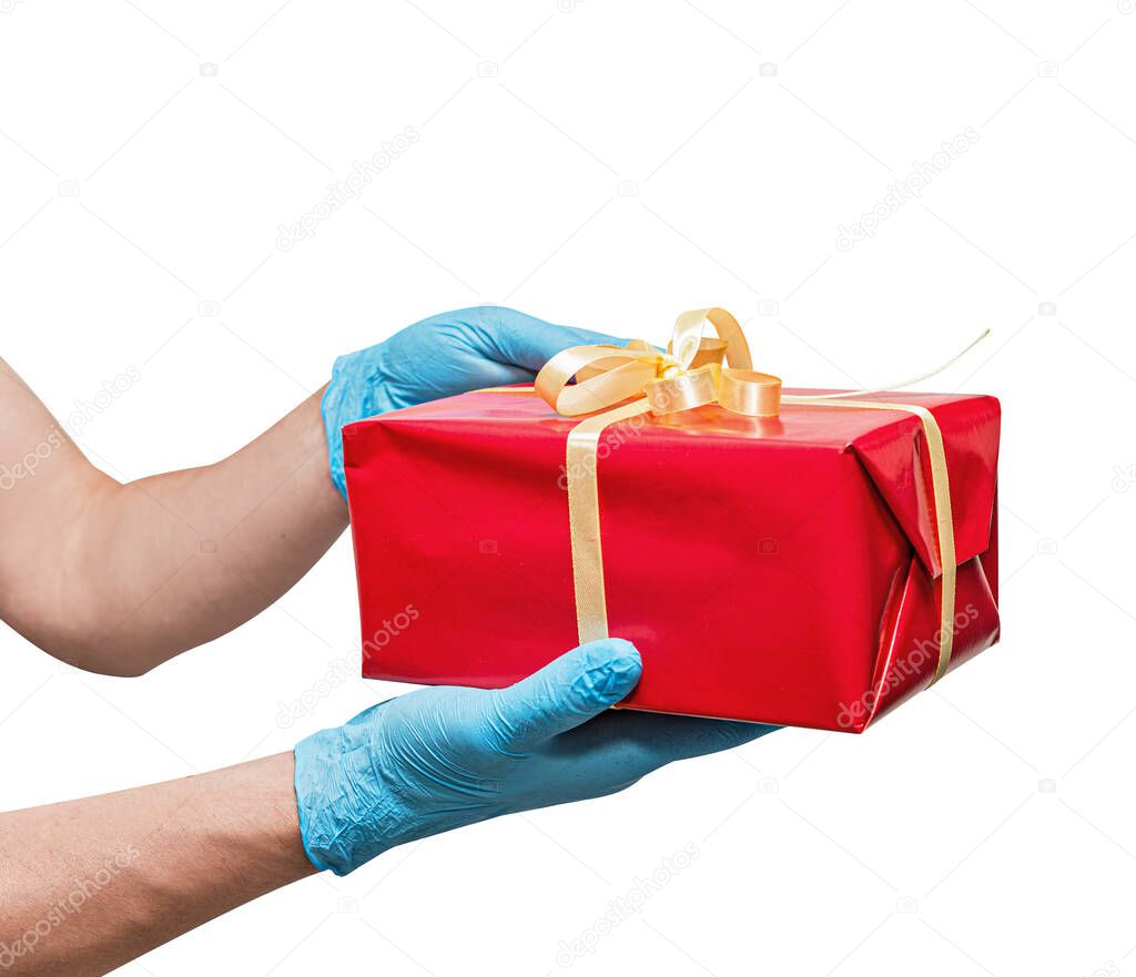 Delivery man employee, with blue surgical gloves holding gift red box. sharing, giving or delivery concept. Isolated on white. Service quarantine pandemic coronavirus virus.