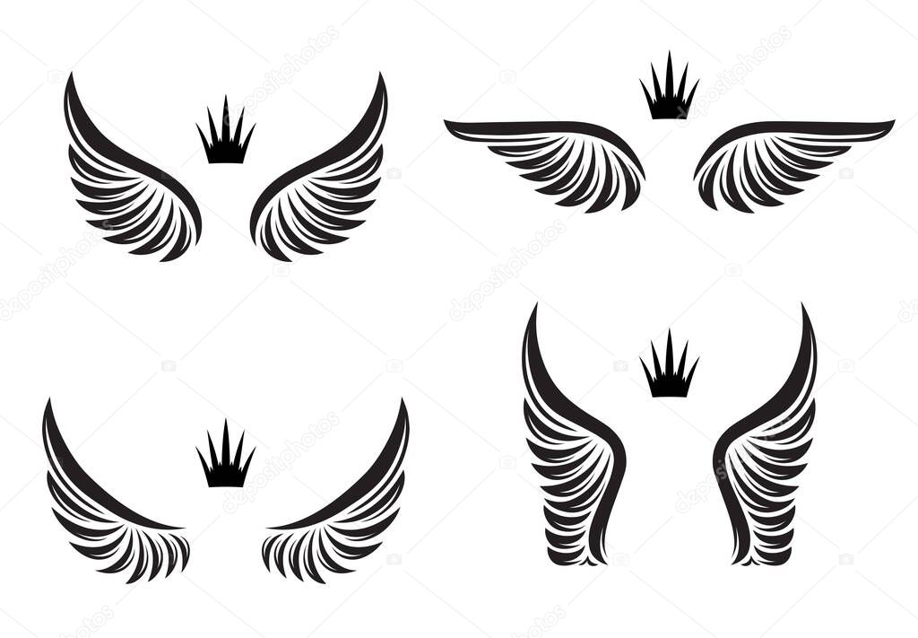 Set of four pairs of wings with crowns. Vector illustration.