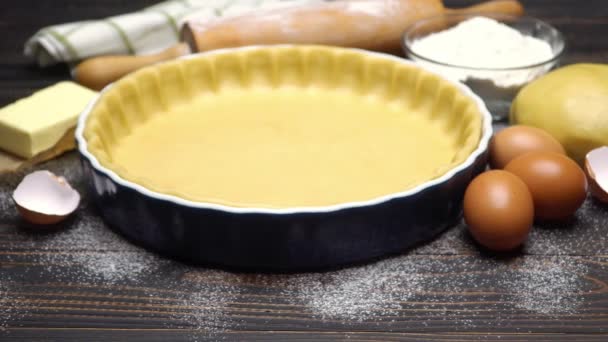 Shortbread dough for baking quiche tart and ingredients in baking form — Stock Video