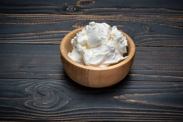 Традиційний сир маскарпоне в дерев'яній мисці на столі — стокове фото