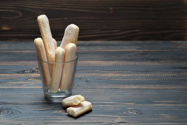 Galletas tradicionales italianas Savoiardi ladyfingers en vidrio sobre fondo de madera — Foto de Stock