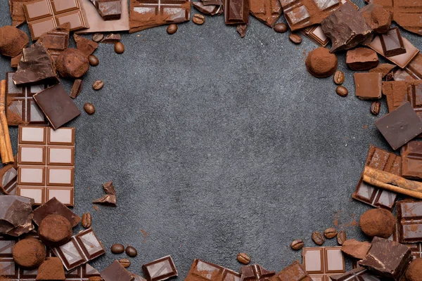 Morceaux de chocolat bio noir ou au lait, poudre de cacao et bonbons à la truffe sur fond de béton noir — Photo