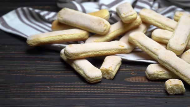 Italian Savoiardi ladyfingers Biscuits on wooden backgound — Stock Video