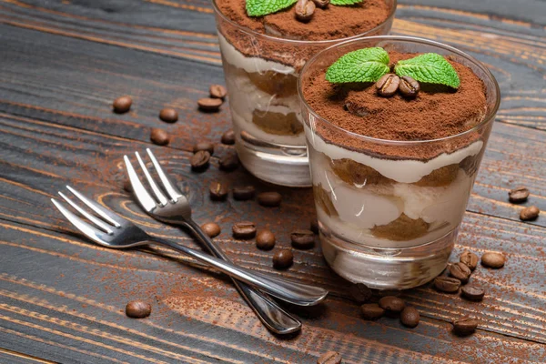 Two portions Classic tiramisu dessert in a glass on wooden background — Stock Photo, Image