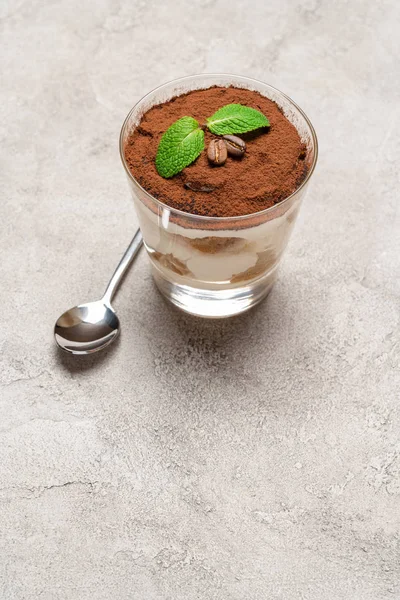 Portion of Classic tiramisu dessert in a glass on concrete background — Stock Photo, Image