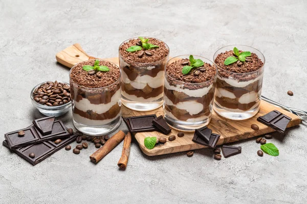 Classico dessert tiramisù in un bicchiere su sfondo di cemento scuro — Foto Stock