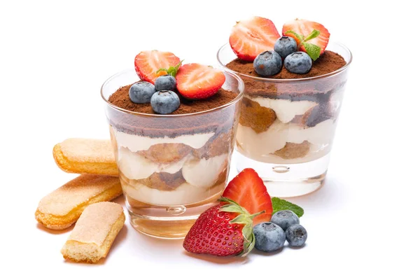 Klassisk tiramisu dessert med blåbär, jordgubbar i ett glas och saviardokex cookies isolerade på en vit med urklippsbana — Stockfoto