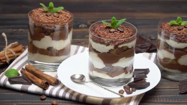 Classic tiramisu dessert in a glass on wooden background — Stock Video