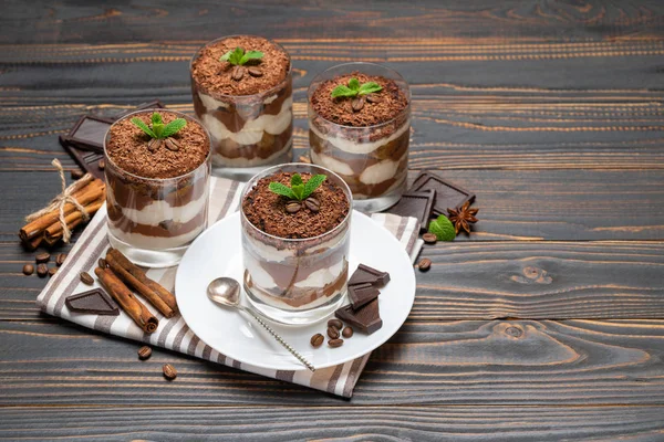 Classic tiramisu dessert in a glass on wooden background — Stock Photo, Image